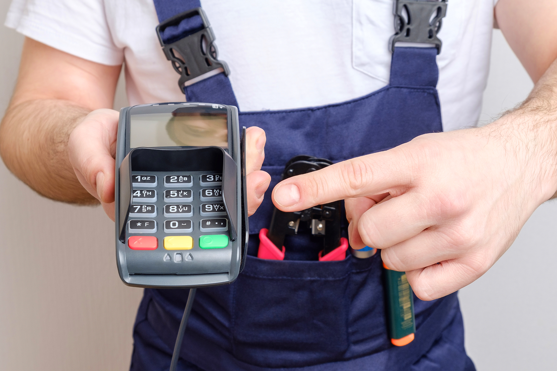 Contractor Holding Portable Debit Machine